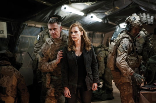 Stationed in a covert base overseas, Jessica Chastain (center) plays a member of the elite team of spies and military operatives who secretly devoted themselves to finding Osama Bin Laden in Columbia Pictures' electrifying new thriller directed by Kathryn Bigelow, ZERO DARK THIRTY.