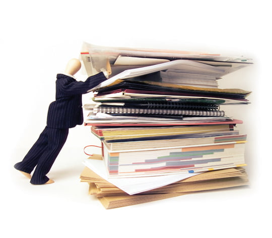 Businessman holding stack of documents