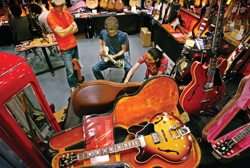 A visitor to Tokyo Guitar Show tries out a classic Gibson as staff helps tuning an amplifier at a local Gibson shop's booth in Tokyo Saturday, June 24, 2006. The Gibson isn't sold anywhere else but in guitars-loving Japan where the entire limited edition of the electric guitars are sold out, underlining this nation's never-ending love affair with American guitars. (AP Photo/Junji Kurokawa)

<저작권자 ⓒ 2006 연 합 뉴 스. 무단전재-재배포 금지.>