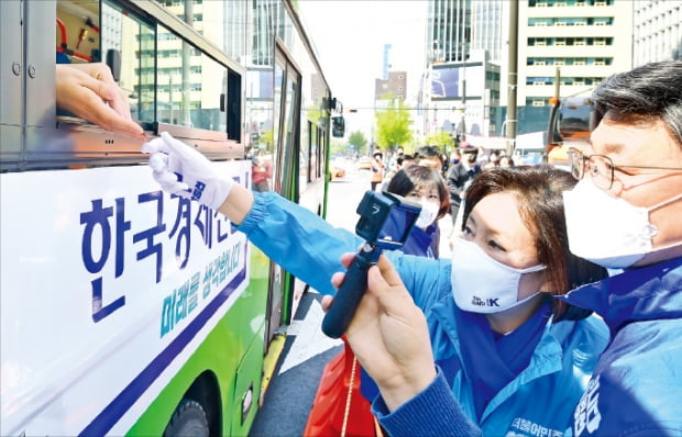 박영선 더불어민주당 서울시장 후보가 6일 서울 광화문에서 버스에 타고 있는 시민과 악수하고 있다.  국회사진기자단
 