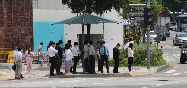 초여름 날씨를 보인 지난 2일 서울 종로구 안국역 인근 그늘막 아래에서 시민들이 횡단보도 보행신호를 기다리고 있다. 사진=뉴스1