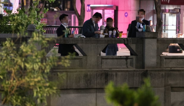 지난4월26일 밤 22시30분께 서울 중구 청계천에서 시민들이 다리 위에서 음주와 취식을 하고 있다.사진=연합뉴스