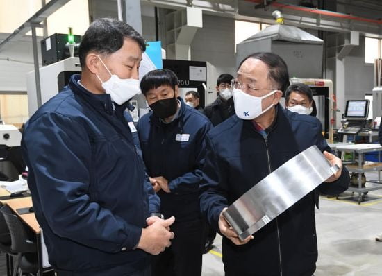 동원파츠를 방문한 홍남기 경제부총리 겸 기획재정부 장관이 제품을 살펴보고 있다. 사진=기획재정부