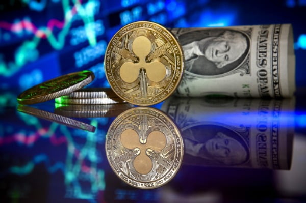 A Ripple coin in front of a monitor showing a stock barometer in Duesseldorf, Germany, 20 January 2021. 한경DB