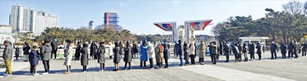 16일 서울 방이동 올림픽공원에 설치된 선별진료소에서 시민들이 코로나19 검사를 받기 위해 길게 줄을 서 있다. 오미크론 확산세가 빨라지면서 15일 신규 확진자는 9만444명으로 하루 만에 두 배 가까이로 급증했다.   /김범준 기자 