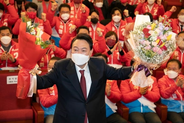 윤석열 제20대 대통령 당선인이 10일 새벽 서울 여의도 국회도서관에 마련된 '국민의힘 제 20대 대통령선거 개표상황실'에서 꽃다발을 들고 포즈를 취하고 있다. /사진=연합뉴스