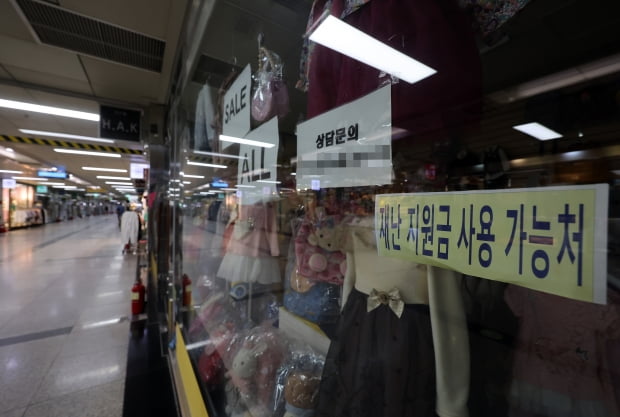 29일 오후 서울 명동 인근 지하상가의 한 매장에 재난지원금 사용가능 문구가 붙어 있는 모습. 사진=연합뉴스