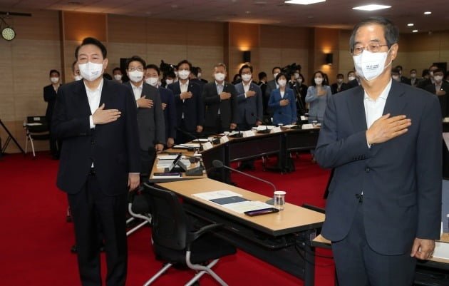 윤석열 대통령이 지난 7일 충북 청주 충북대학교에서 열린 국가재정전략회의에 앞서 한덕수 국무총리(오른쪽)를 비롯한 참석자들과 국기에 대한 경례를 하고 있다. 대통령실사진기자단