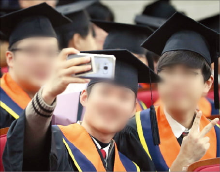 서울의 한 고등학교 졸업식에서 학생들이 기념 셀카를 찍고 있다.  한경DB 