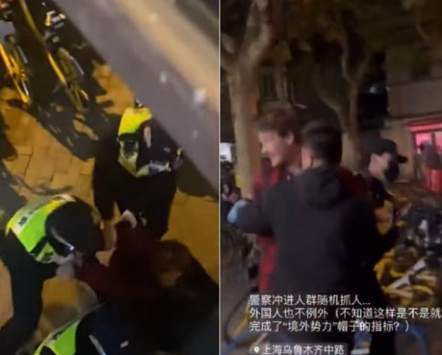 에드 로런스 BBC 기자가 27일(현지 시각) 상하이에서 시위를 취재하던 중 수갑이 채워진 채 당국에 의해 연행되고 있다. /캡처=SNS