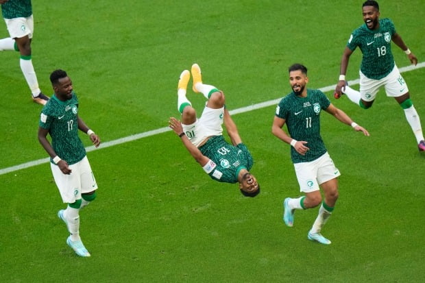 Saudi Arabia's Salem Al Dawasari (second from left) celebrates following scoring his team's second goal during the World Cup Group C match between Argentina and Saudi Arabia at Lusail Stadium on November 22, 2022 / photo = A.P.