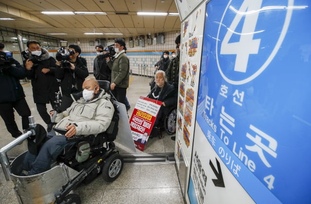 전국장애인차별철폐연대(전장연) 회원들이 13일 오전 서울 용산구 삼각지역에서 장애인 권리 예산 확보를 위한 지하철 타기 선전전을 위해 이동하고 있다.  / 사진=뉴스1