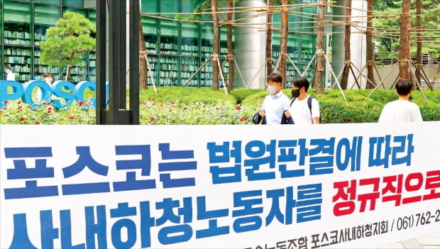 대법원이 협력업체 근로자를 포스코가 직접 고용하라는 판결을 내린 지난해 7월28일 서울 대치동 포스코 사옥 앞을 시민들이 지나가고 있다. 사옥 앞에는 금속노조 포스코사내하청지회에서 내건 현수막이 걸려 있다. 한경DB