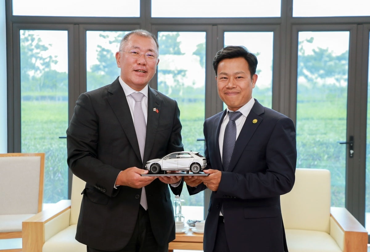 정의선 현대자동차그룹 회장(왼쪽)과 레 꾸언 하노이 국립대 총장이 23일(현지시간) 하노이 국립대 호아락 캠퍼스에서 만나 아이오닉 5 모형을 들고 기념 촬영을 하고 있다. 현대차그룹 제공