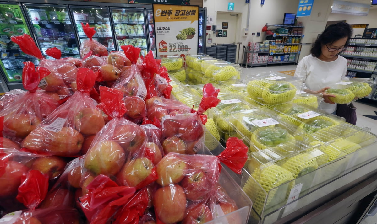 서울시내의 한 대형마트에서 한 소비자가 가격이 오른 사과 대신 상대적으로 저렴한 샤인머스캣을 고르고 있다. 한경DB