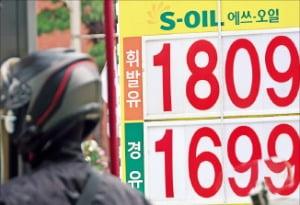오토바이 운전자가 3일 서울의 한 주유소에서 기름을 넣고 있다. 주유소 휘발유 가격은 지난달 마지막 주까지 12주 연속 올랐다.  연합뉴스 