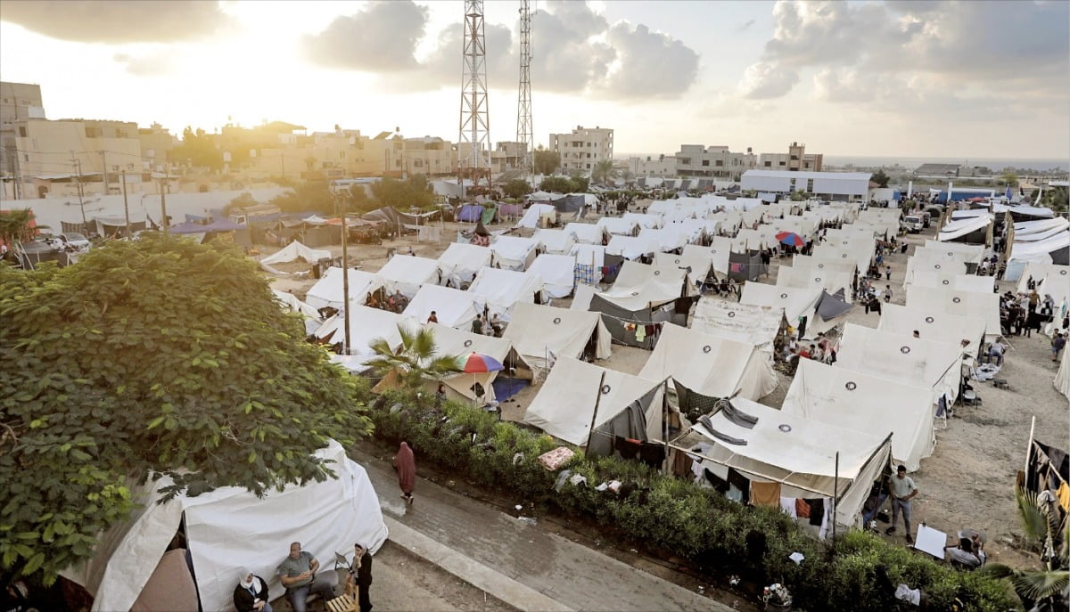 < 유엔, 팔레스타인 난민캠프 마련 > 유엔개발계획(UNDP)이 19일(현지시간) 팔레스타인의 가자지구 칸 유니스에 피란민이 머물 수 있는 난민캠프를 마련했다. 유엔에 따르면 이스라엘-팔레스타인 간 분쟁 발발 이후 가자지구에서는 약 100만 명의 난민이 발생했고, 이 중 51만3500명이 유엔 시설에 수용돼 있다.    /EPA연합뉴스 