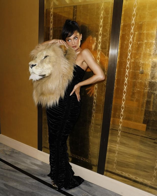 Youngest billionaire has a giant stuffed lion head on his shoulder