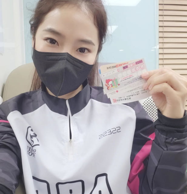 Hongja takes a snap with a blood donation certificate