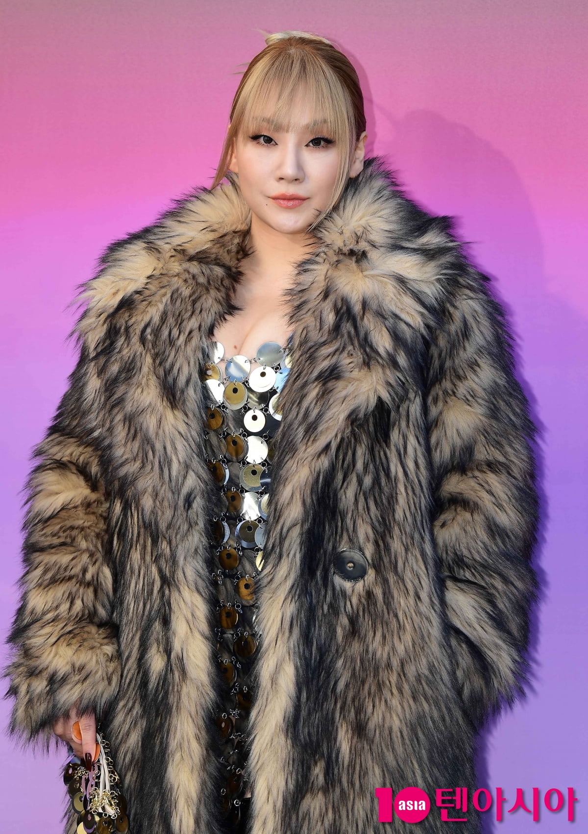 CL, sexy metal dress between fur coats 