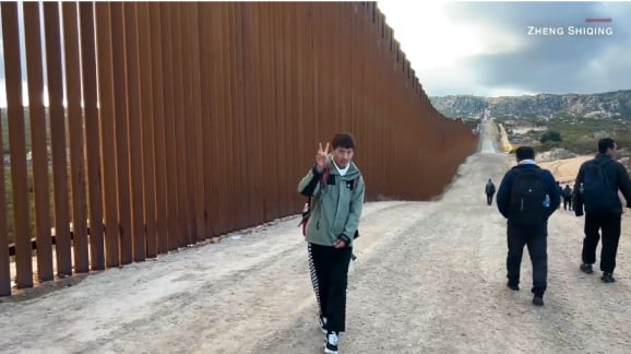한 중국인 청년이 미국 국경을 넘어 걷고 있다. 