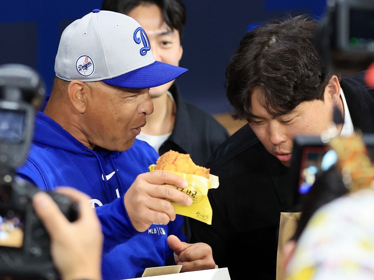 20일 서울 구로구 고척스카이돔에서 열리는 2024 미국 메이저리그(MLB) 월드투어 서울시리즈  개막전 샌디에이고 파드리스와 로스엔젤레스(LA) 다저스의 경기를 앞두고 데이브 로버츠 다저스 감독이 올시즌 KBO리그 개막을 앞두고 한화 이글스로 전격 컴백한 류현진이 선물한 빵을 맛있게 먹고 있다. 사진=뉴스1