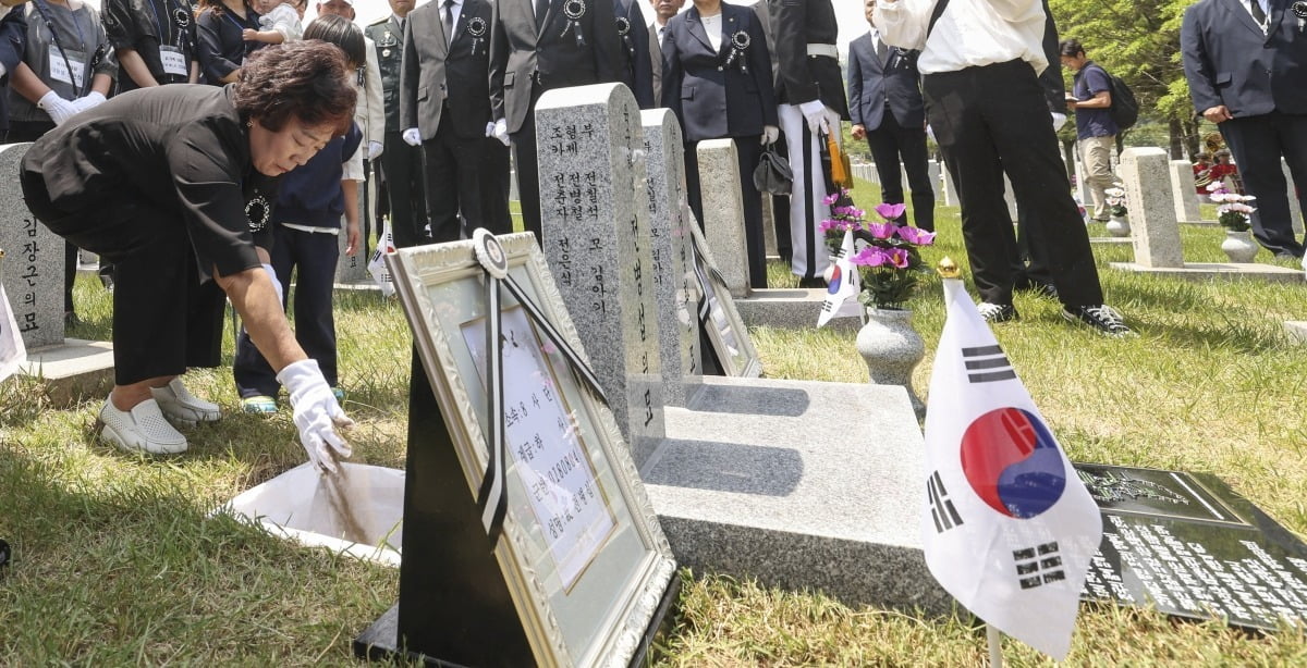 5일 오전 서울 동작구 국립서울현충원에서 열린 '호국의 형제 6호' 안장식에서 유가족들이 故 전병섭 하사의 유해에 허토를 하고 있다.