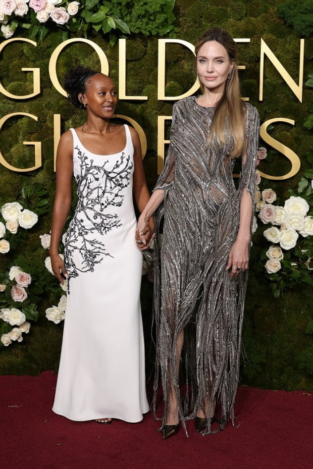 BEVERLY HILLS, CALIFORNIA - JANUARY 05: (L-R) Zahara Jolie and Angelina Jolie attend the 82nd Annual Golden Globe Awards at The Beverly Hilton on January 05, 2025 in Beverly Hills, California. (Photo by Kevin Mazur/Getty Images)