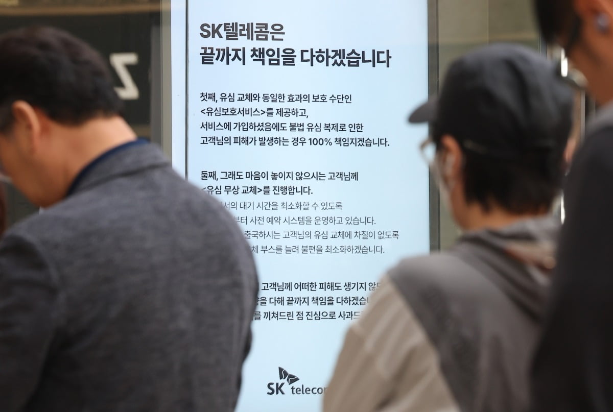 가입자 유심(USIM) 정보를 탈취당한 SK텔레콤이 유심 무료교체 서비스를 시작한 지 이틀째인 29일 서울 시내 한 SKT 대리점에 'SK텔레콤은 끝까지 책임을 다하겠습니다'라는 문구가 쓰여져 있다. 사진=연합뉴스