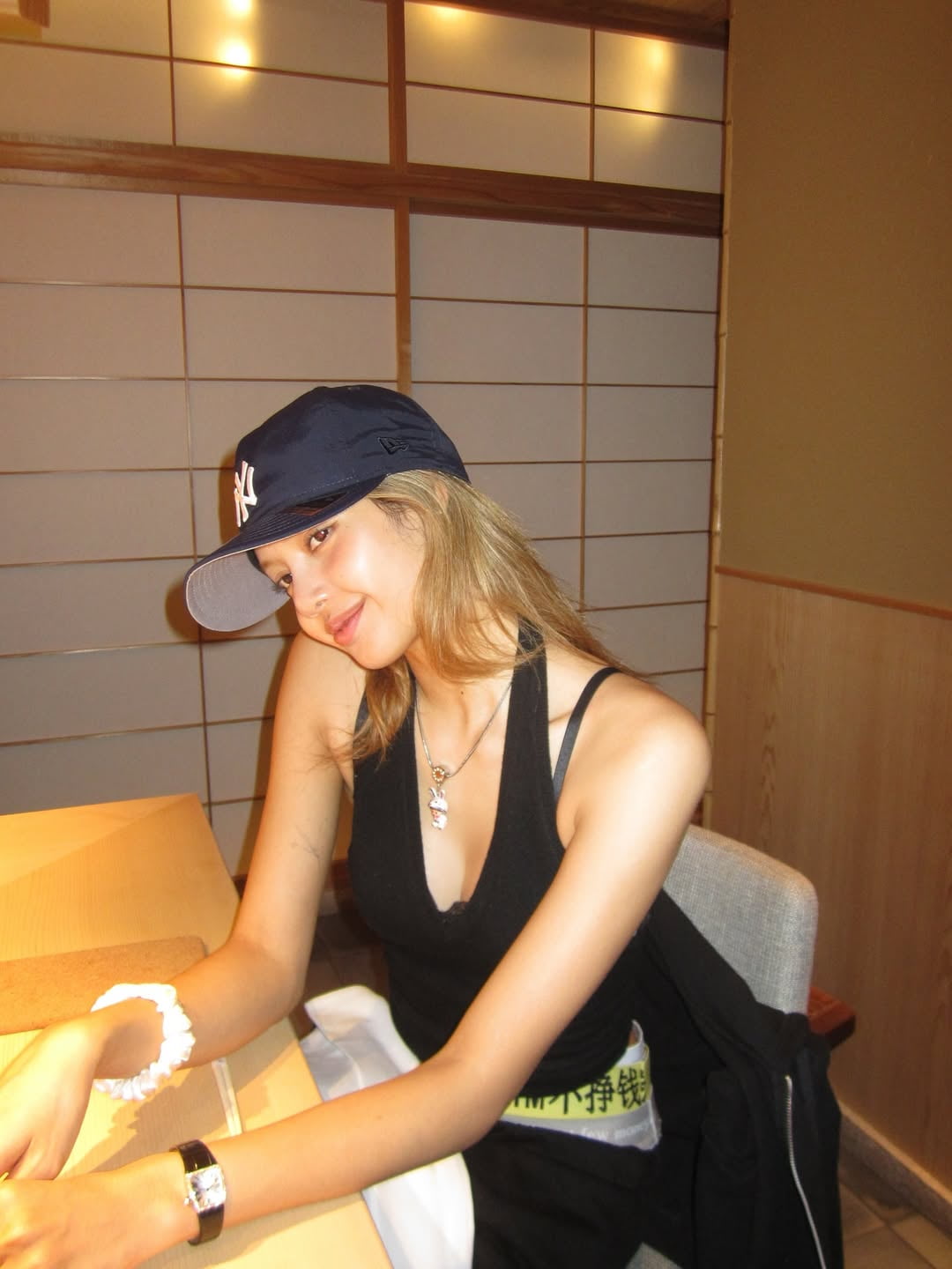 Lisa Shares Contrasting Moments with Sushi Bar Snap and Sheer Black Dress Mirror Shot