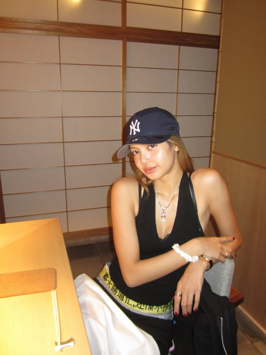 Lisa Shares Contrasting Moments with Sushi Bar Snap and Sheer Black Dress Mirror Shot
