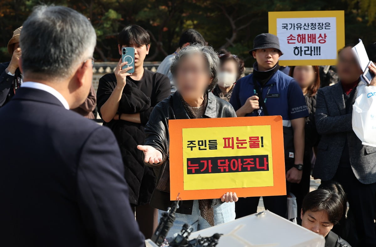 허민 국가유산청장이 지난 7일 서울 종묘 정전 하월대에서 종묘 앞 개발 규제 완화 관련 대법원 판결에 대한 입장 발표 기자회견 중 세운 4구역 주민들의 항의를 받고 있다. 뉴스1