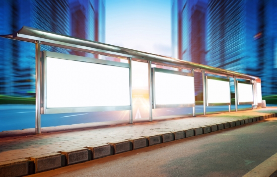 Blank billboard on bus stop at night