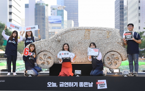 보건복지부 주최로 25일 오전 서울 종로구 청계광장에서 열린 '오늘 금연, 담배꽁초 자동차' 전시 행사에서 모델들이 전 국민 흡연 예방 및 흡연자에 대한 금연 캠페인을 진행하고 있다. 6년간 매일 하루 1갑의 담배를 흡연할 경우 지출되는 담뱃값이 소형 승용차 한 대를 구매할 수 있는 금액이라는 점에 착안하여 약 12만 개의 담배꽁초로 자동차 모형을 제작하여 전시하고 있다./김범준기자bjk07@hankyung.com