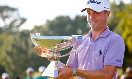 Sep 24, 2017; Atlanta, GA, USA; Justin Thomas hoists the trophy after winning the FedEx Cup following the Tour Championship golf tournament at East Lake Golf Club. Mandatory Credit: Butch Dill-USA TODAY Sports